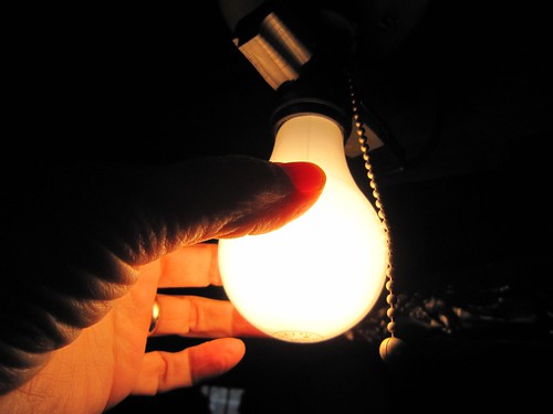 Photograph showing a hand holding a lightbulb